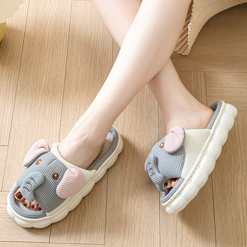 Gray slippers with kawaii cartoon design worn on a wooden floor