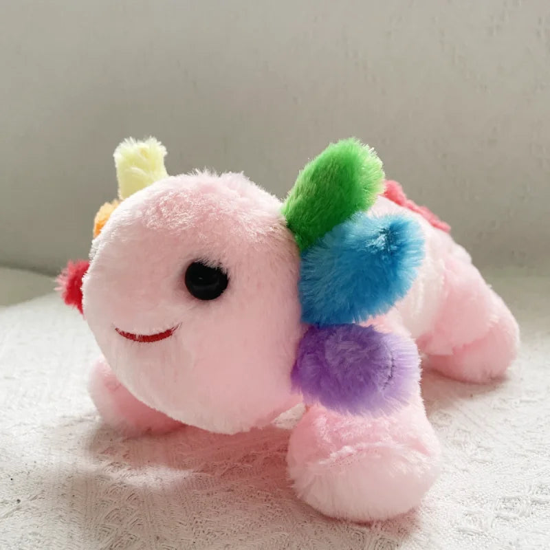 Pink kawaii plush toy with a colorful tail on a light background