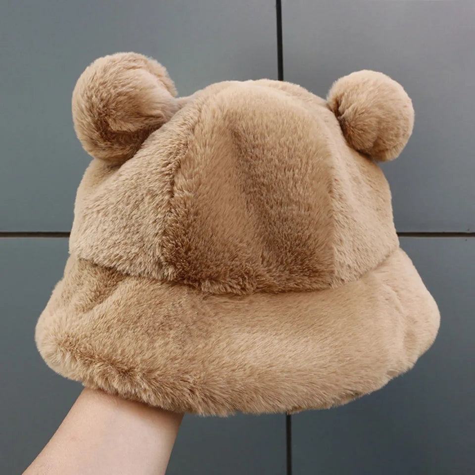 Beige Kawaii plush hat with bear ears held against a gray background