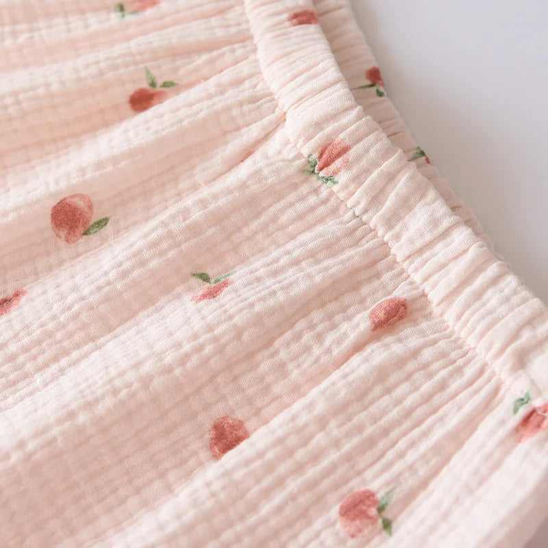 Close-up of a pink textured fabric with small floral kawaii patterns on a white background