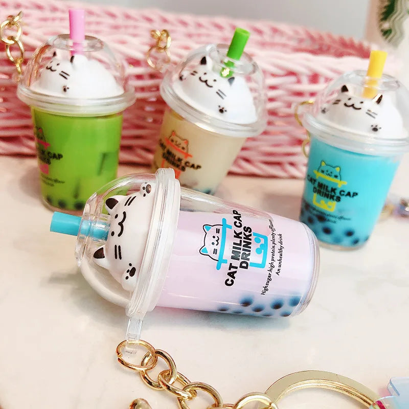 Cat-themed kawaii milk cap drinks with colorful straws on a pink background