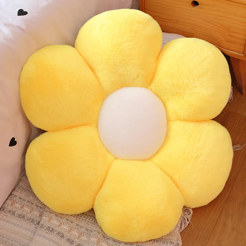 Yellow flower-shaped Kawaii cushion on a wooden floor