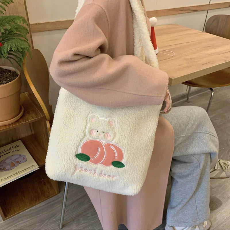 Person holding a fluffy white bag with a kawaii cartoon design in a casual setting.