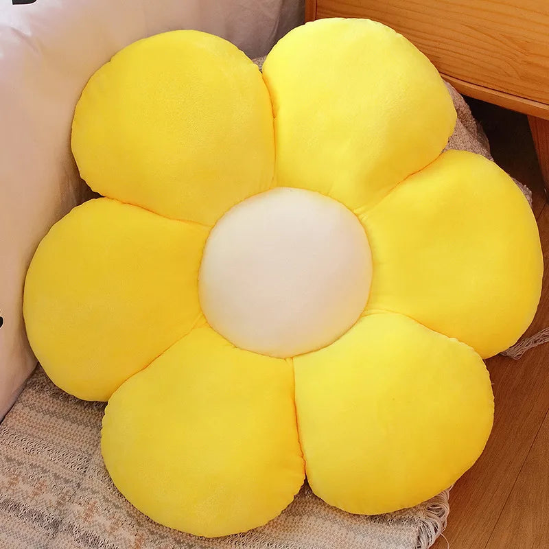 Yellow Kawaii flower-shaped cushion on a wooden floor