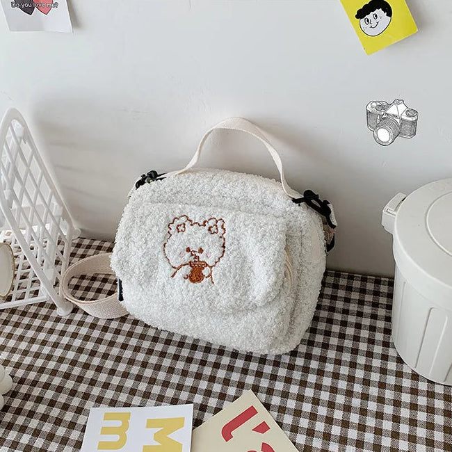 White fluffy pouch with a Kawaii cartoon design on a checkered surface