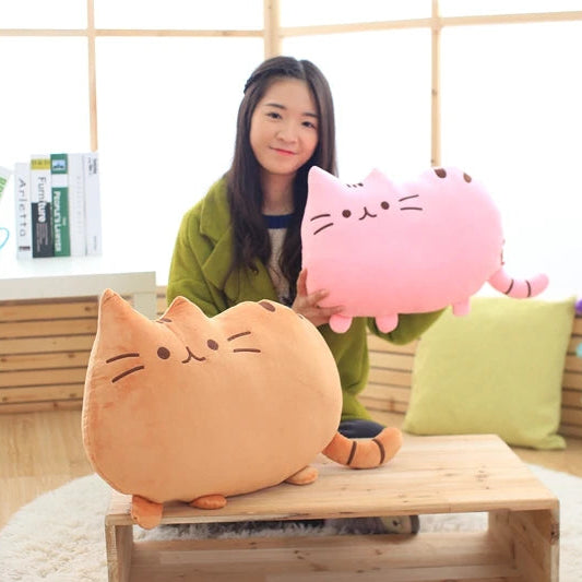 Woman holding a pink cat-shaped plush kawaii toy in a room with wooden flooring and a table.