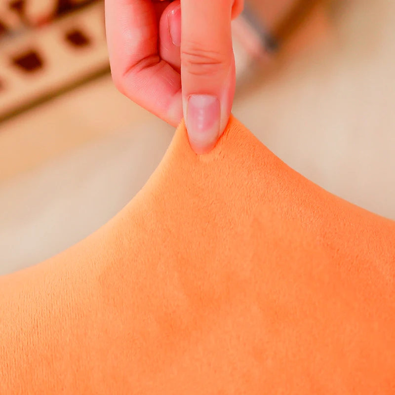 Close-up of a hand adjusting an kawaii orange garment on a blurred background