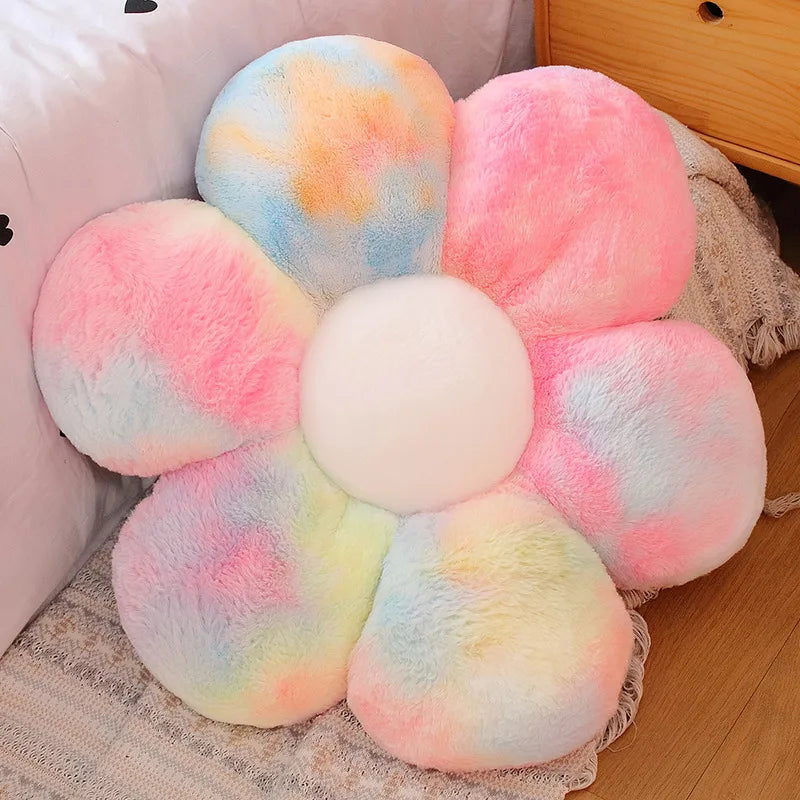 Flower-shaped Kawaii pillow with multicolored petals on a wooden floor.