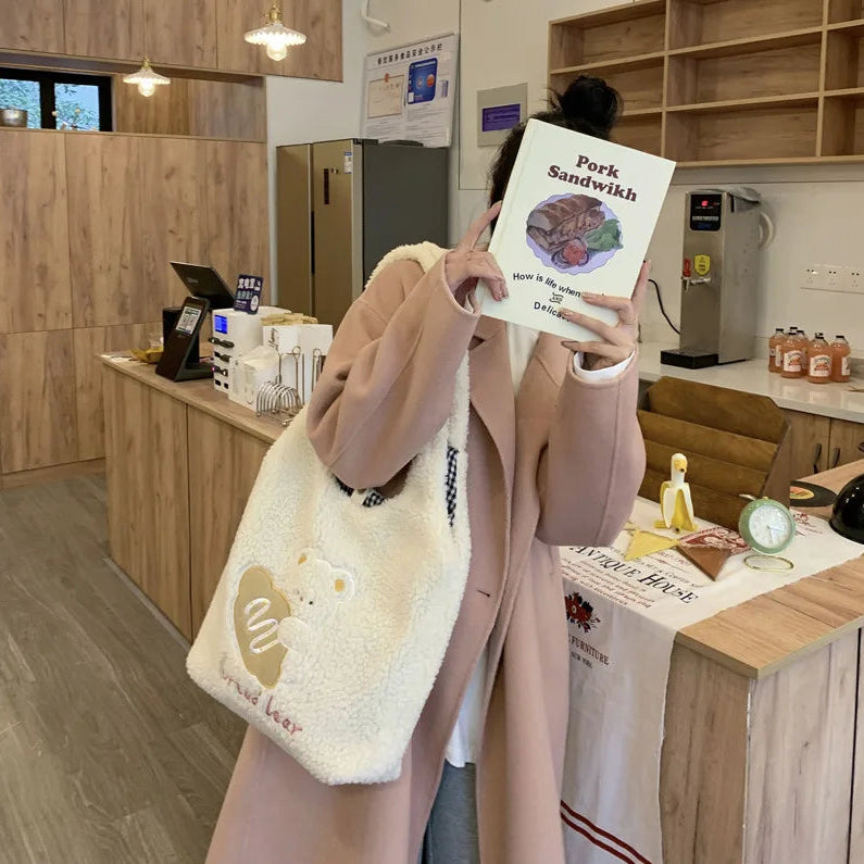 Person holding a menu in a store with kawaii tote bag.