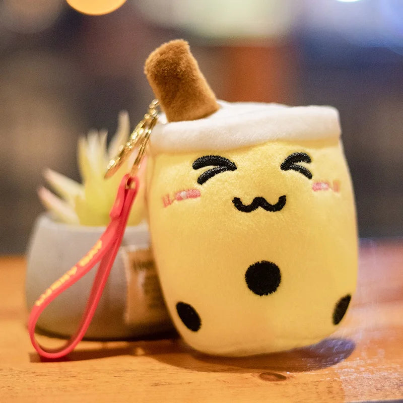 Plush keychain shaped like a kawaii cartoon bubble tea with a blurred background