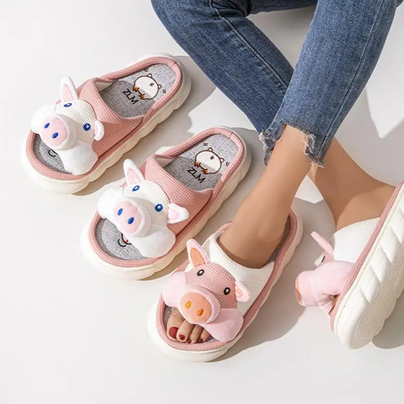 Pink pig-themed kawaii slippers worn with denim jeans on a light background