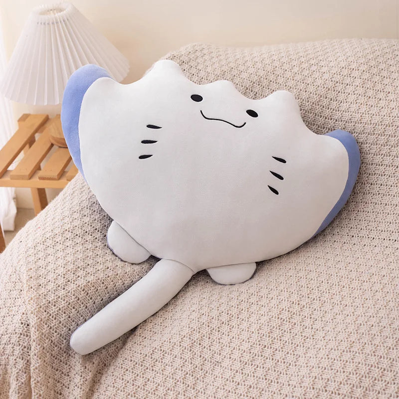 Cute plush cat kawaii toy with a smiley face on a beige surface