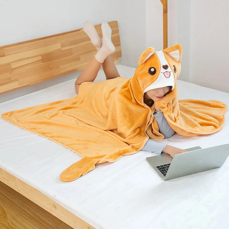 Person wearing a kawaii cartoon animal hoodie on a bed with a laptop.