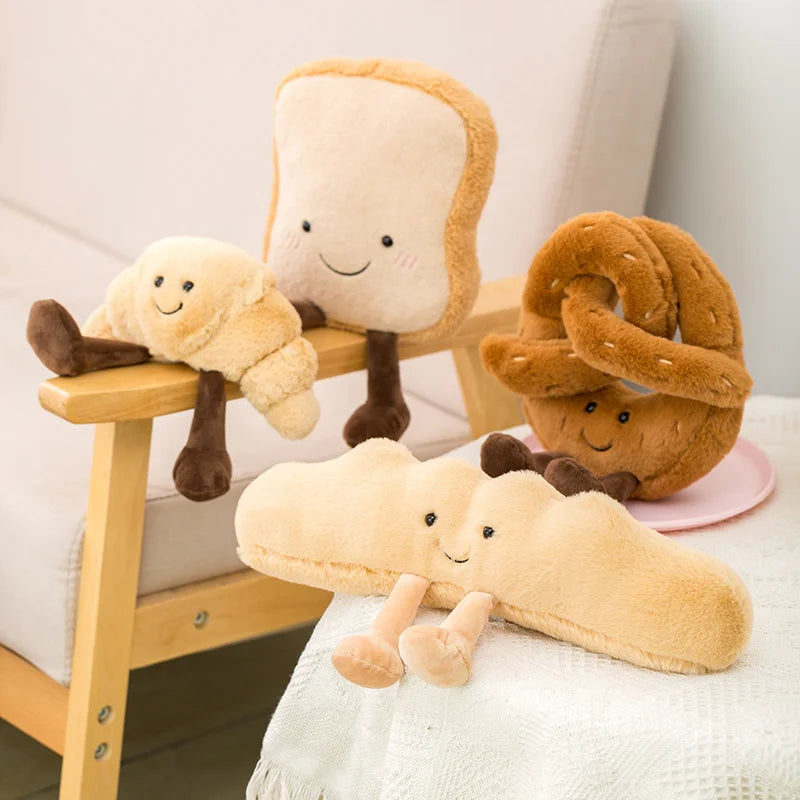 Plush kawaii toys shaped like bread, a bun, and a pretzel on a wooden stand.