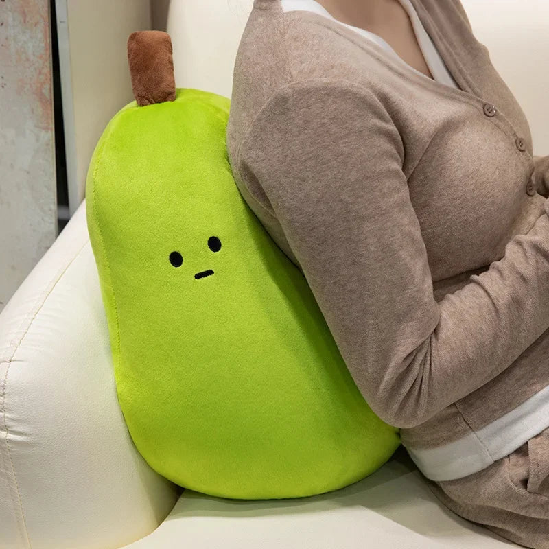 Person sitting on a couch with a green pear-shaped kawaii cushion