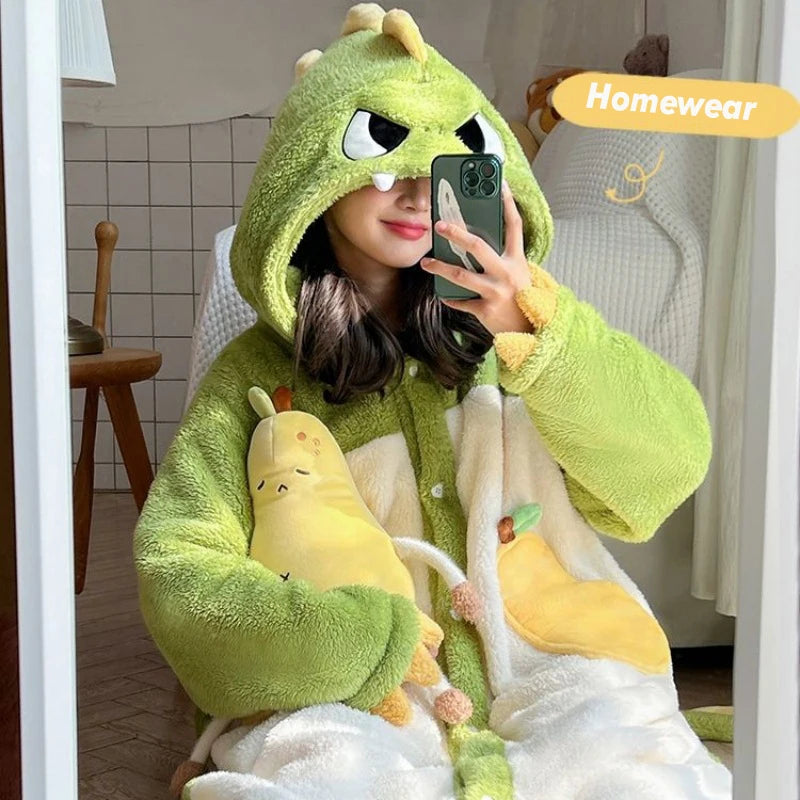 Person wearing a green and white kawaii cartoon-themed onesie with a hood, sitting in a room.