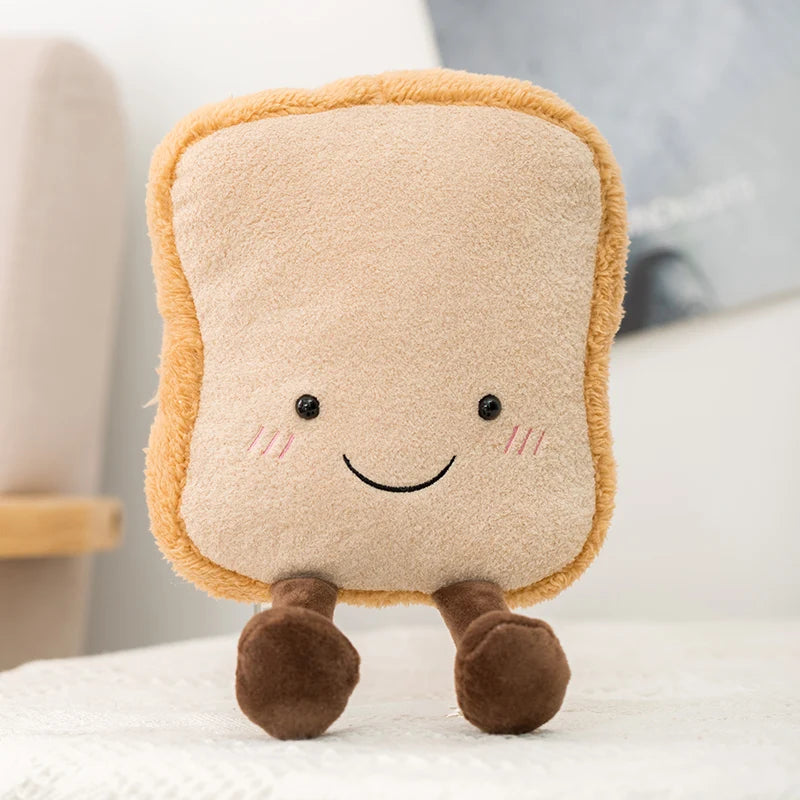 Plush kawaii toy shaped like a square piece of bread with a smiley face on a white surface.