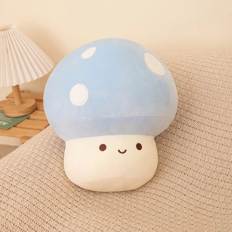 Cute plush mushroom kawaii toy with a blue cap and white spots on a beige surface.
