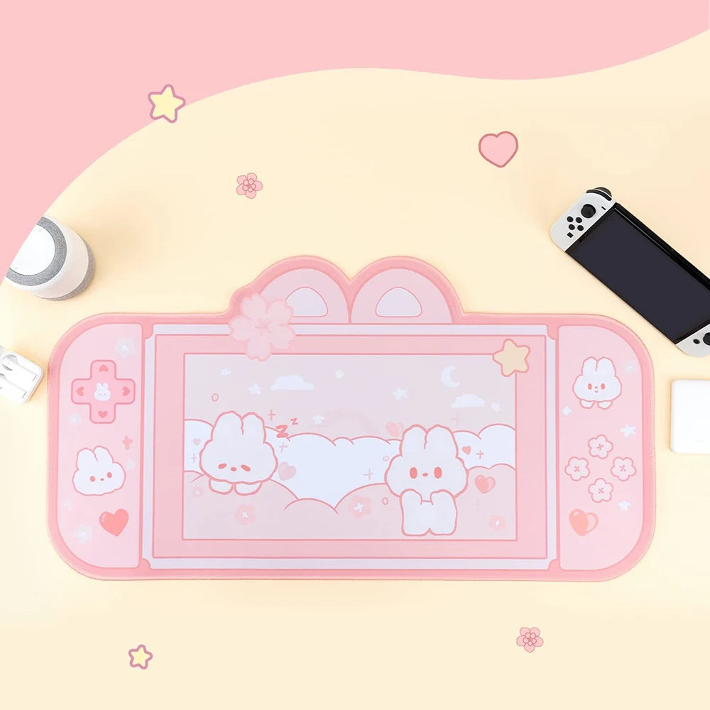 Pink gaming console with Kawaii cartoon characters on a pink background