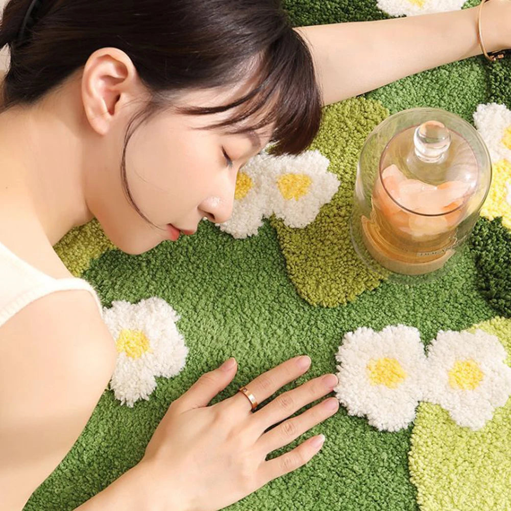 Woman lying on a green surface with kawaii flowers and a glass of tea