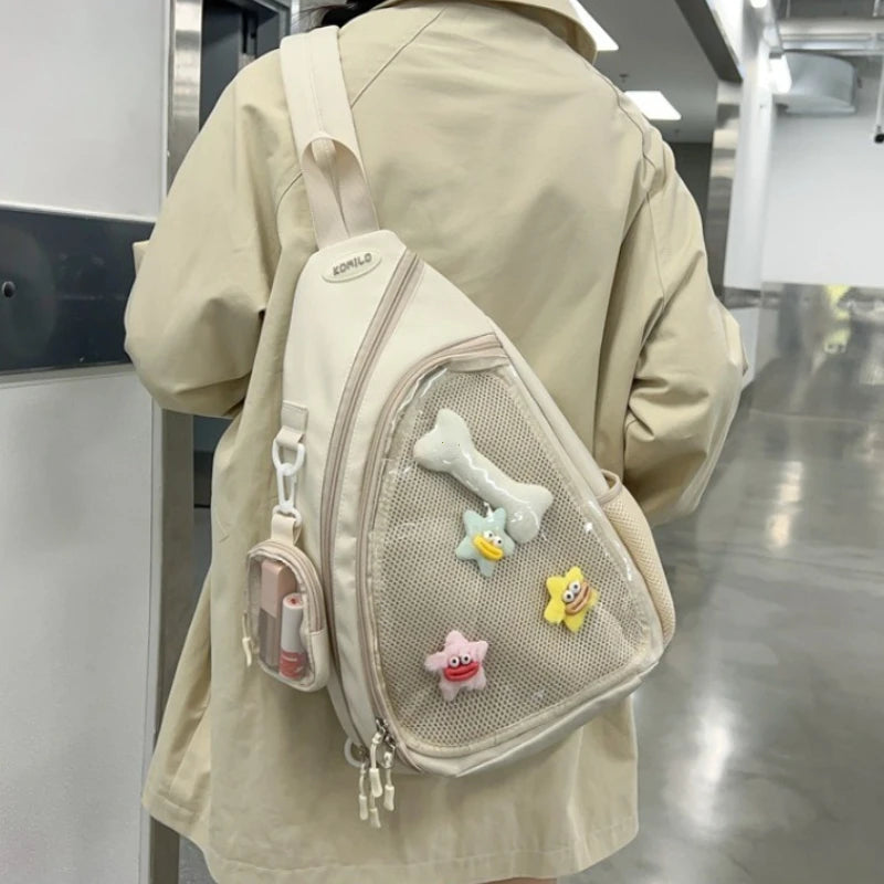 Person wearing a beige sling bag with Kawaii cartoon character decorations in an indoor setting