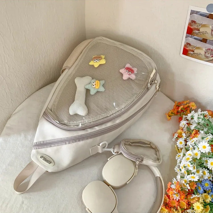 Beige Kawaii bag with toys on a white surface next to flowers