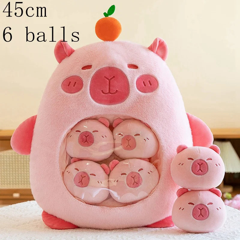 Pink kawaii plush toy shaped like a pig with six smaller pig plush toys inside, on a light background.