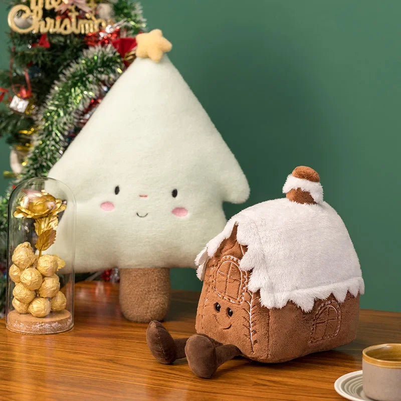 Kawaii plush tree and gingerbread house with a Christmas tree and gold gift in the background.