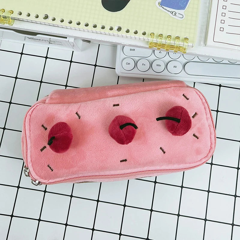 Pink pencil case with kawaii cherry design on a grid background