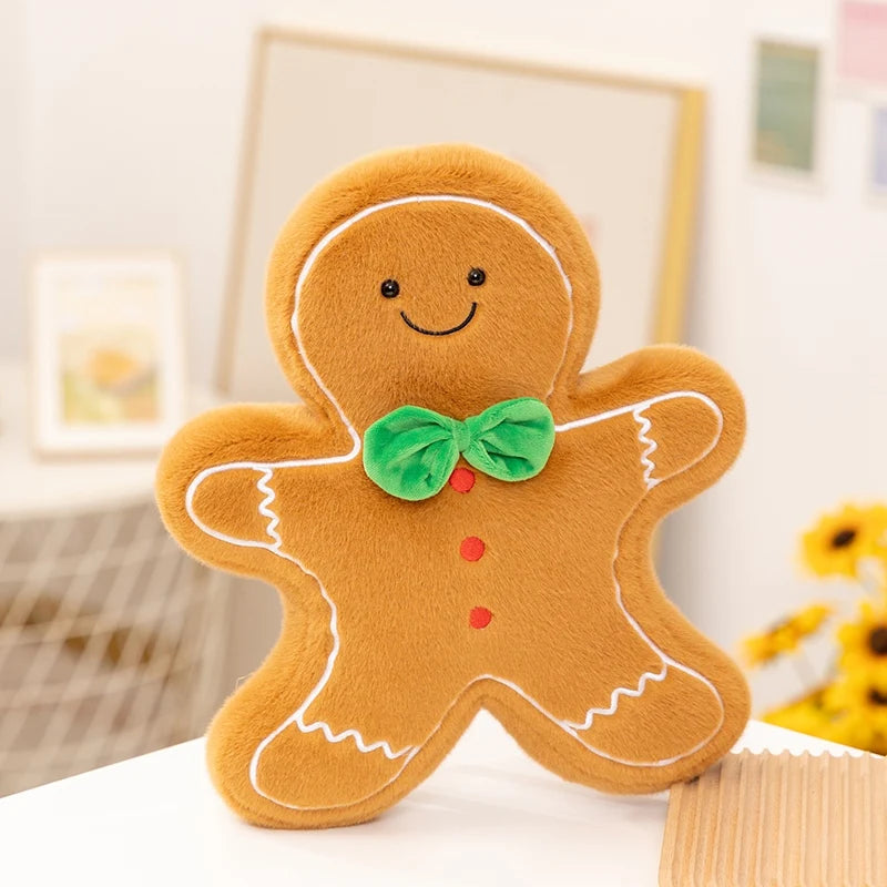 Kawaii plush gingerbread man toy with a green bow tie on a white surface.