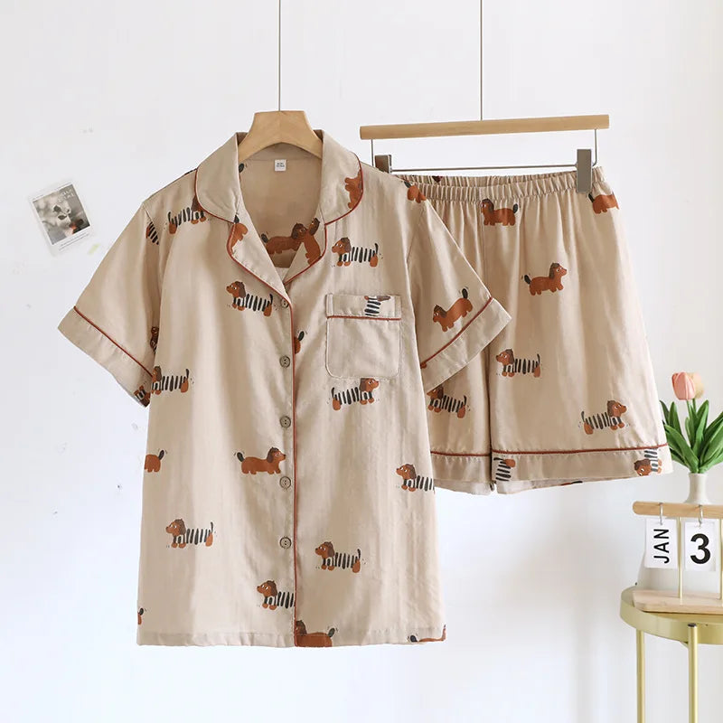 Beige kawaii pajama set with dog pattern on a hanger against a white background