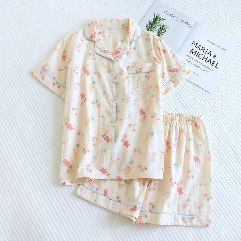 Floral kawaii pajama set on a white textured surface with a magazine underneath.
