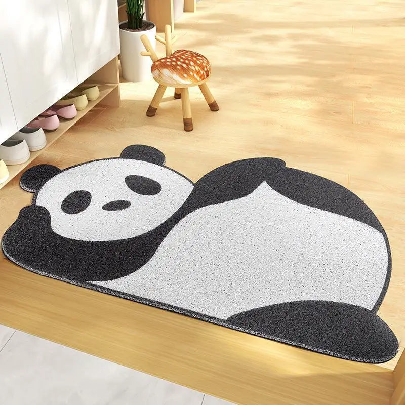 Kawaii panda-shaped rug on a wooden floor with a child's stool and shoes in the background.