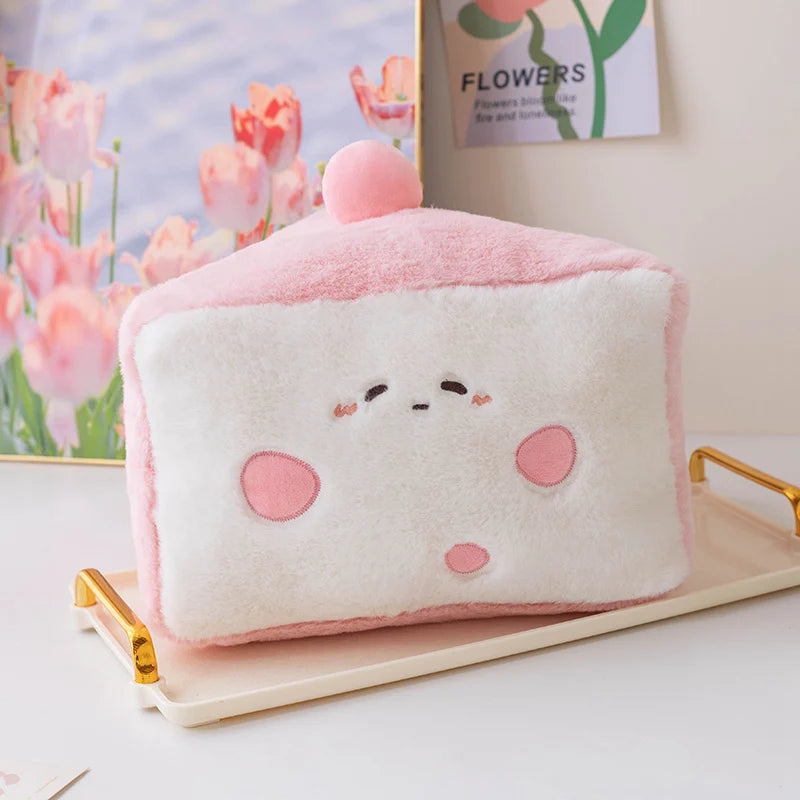 Cute pink and white plush pillow with kawaii cartoon face on a decorative tray.