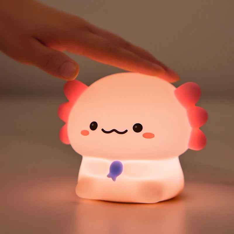 Cute cartoon-style kawaii night light with a hand touching it, on a neutral background