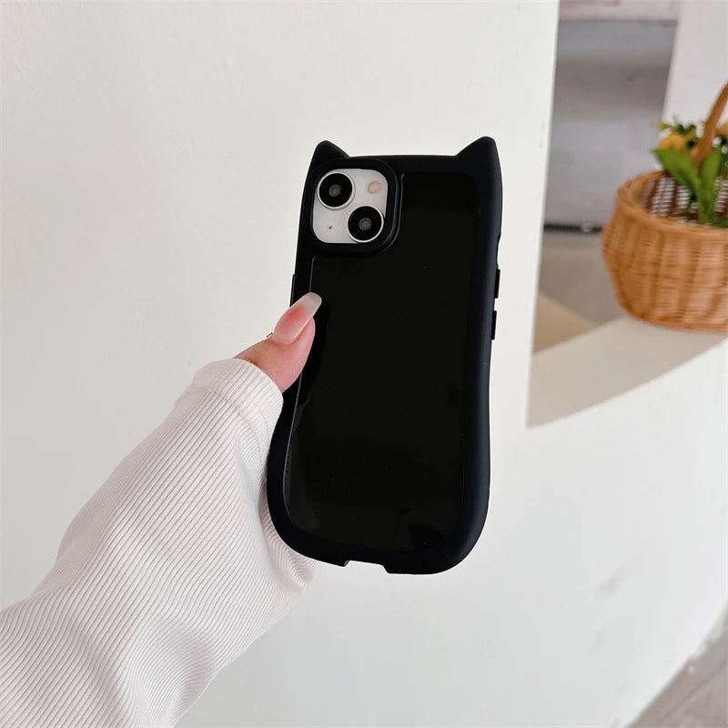 Person holding a black kawaii phone case with a cat ears design.