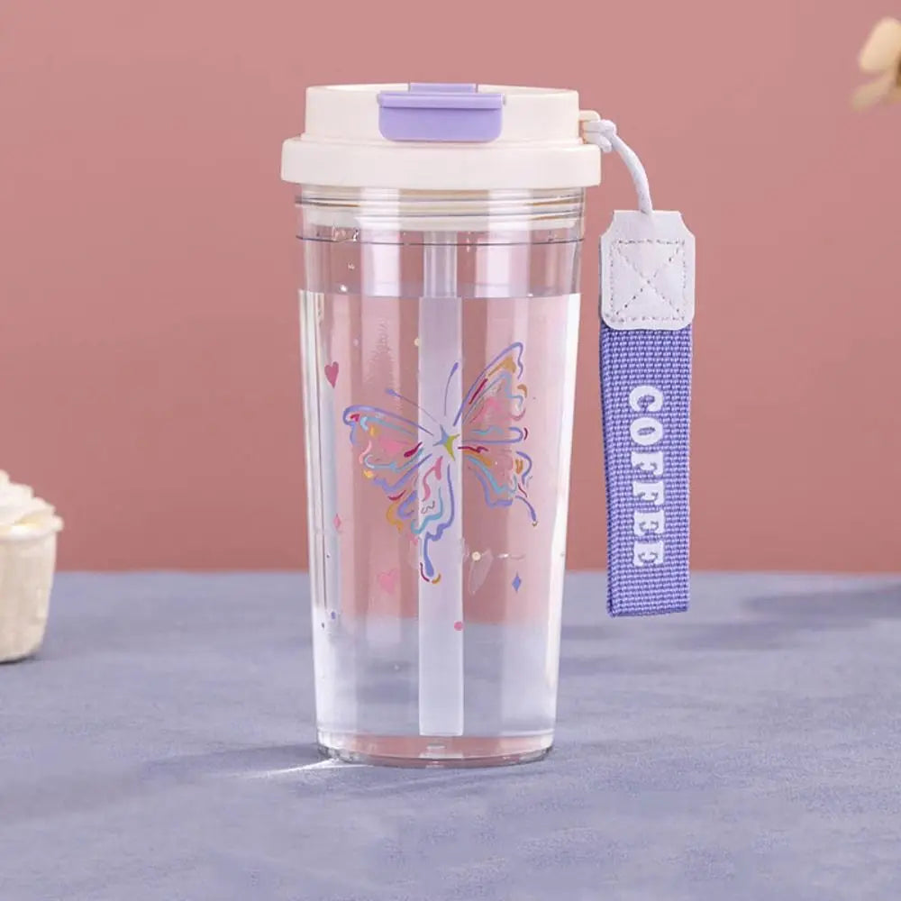 Clear tumbler with butterfly Kawaii design and purple straw sleeve on a pink background