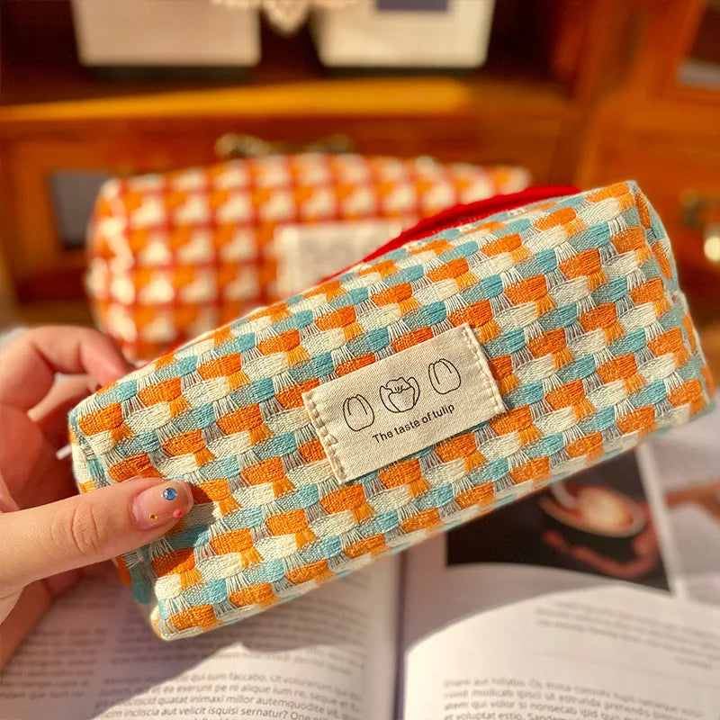 Patterned kawaii pouch held by a hand with a blurred background