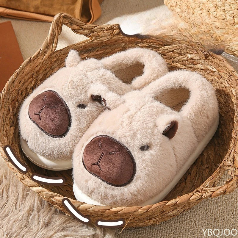Pair of plush animal kawaii slippers with brown faces in a woven basket on a soft surface.