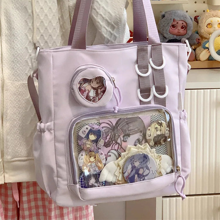 Kawaii backpack with character designs held by a person, with toys in the background.