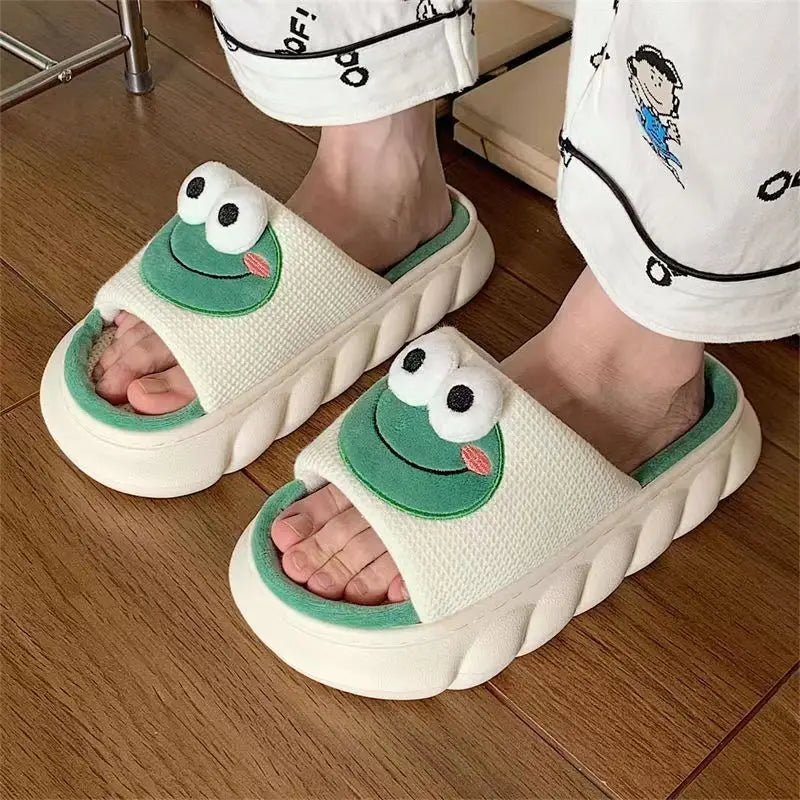 White slippers with frog kawaii design worn on a wooden floor