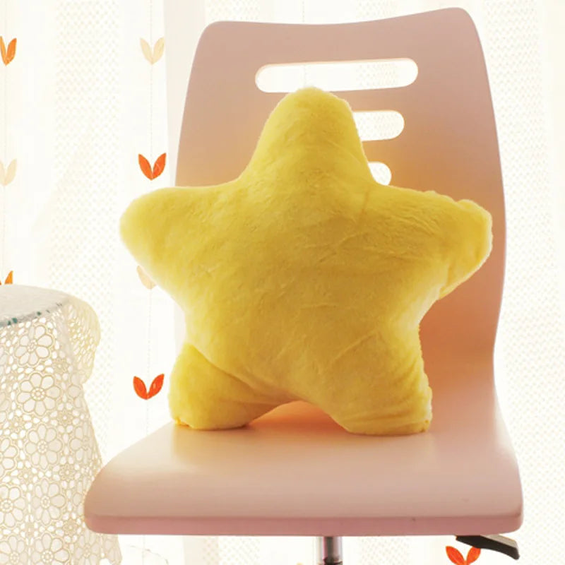 Yellow star-shaped Kawaii pillow on a pink chair with a light background