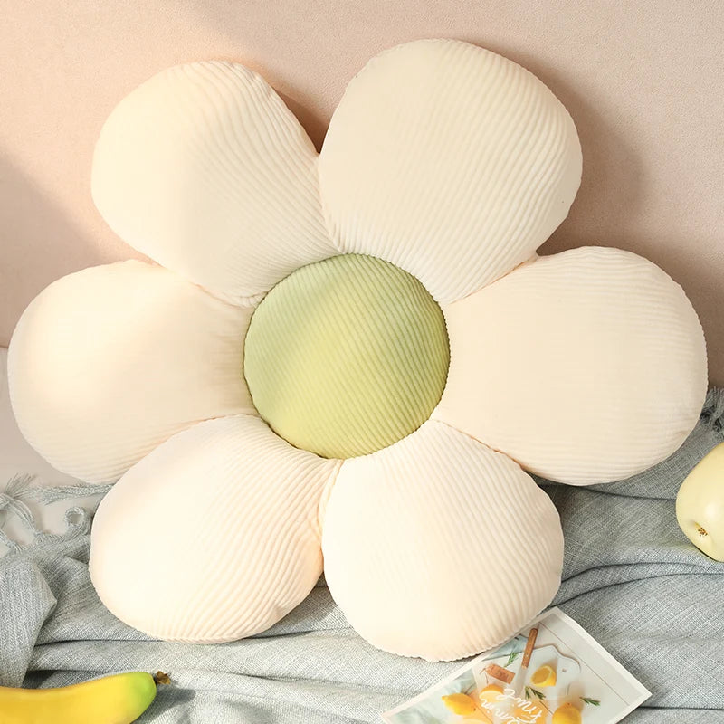 Flower-shaped Kawaii pillow with a green center on a soft surface