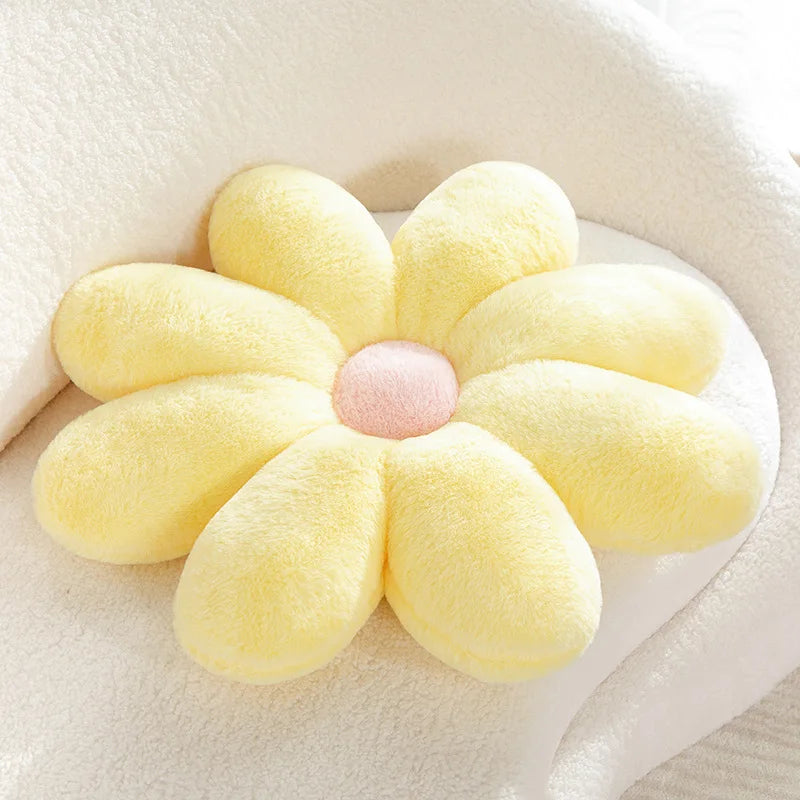 Flower-shaped Kawaii pillow with yellow petals and a pink center on a white background