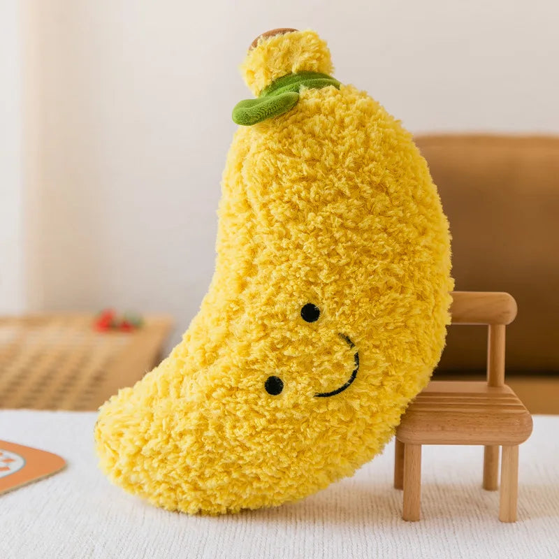 Yellow kawaii plush toy shaped like a pear with a smiley face on a light-colored surface.