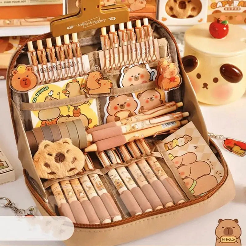 Set of stationery items with kawaii cartoon bear designs in a beige case.