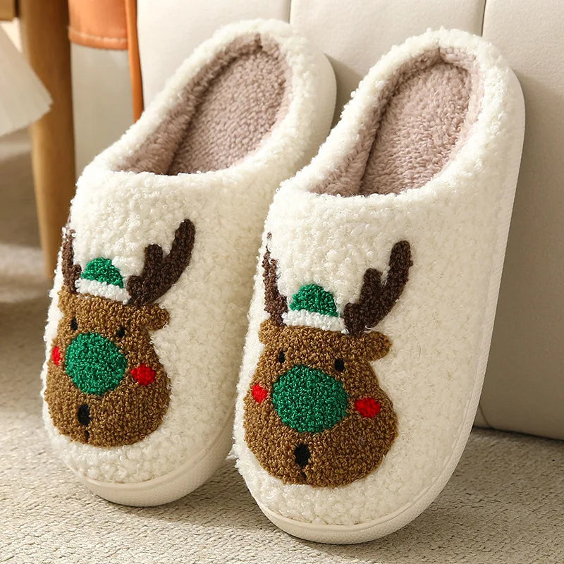 Pair of white slippers with kawaii reindeer face design on a light background