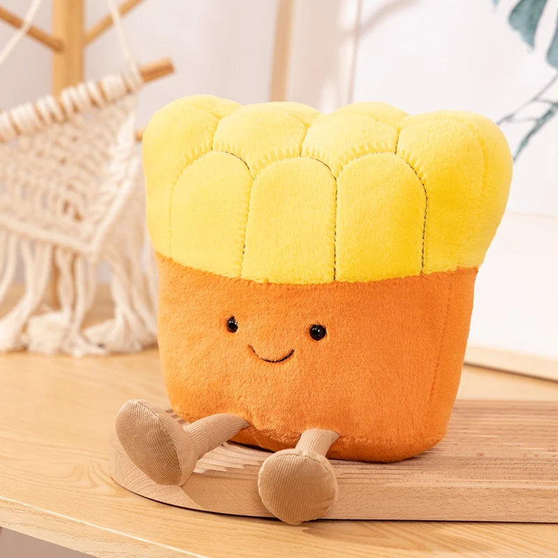 Plush kawaii toy resembling a corn on the cob with a smiling face on a wooden surface.