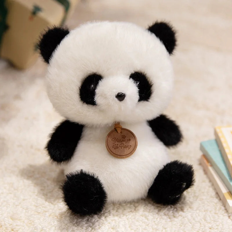 Plush panda kawaii toy with a tag on a soft surface