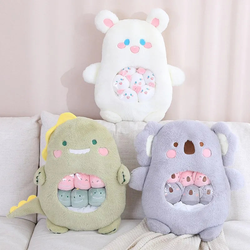 Three kawaii plush toys resembling a bear, a dragon, and a koala on a light-colored couch.